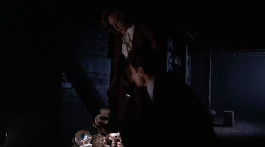 Mulder and Scully look at evidence in Squeeze