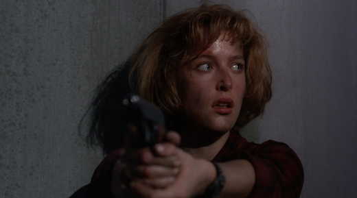 Scully keeps her gun trained on Peterson as she looks at Mulder.