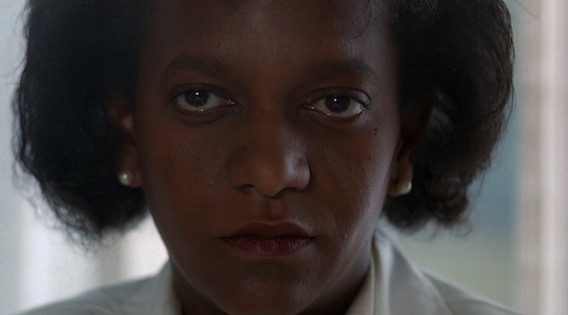 A woman makes a deadpan face.