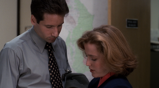 Mulder and Scully crowd each other's personal space.