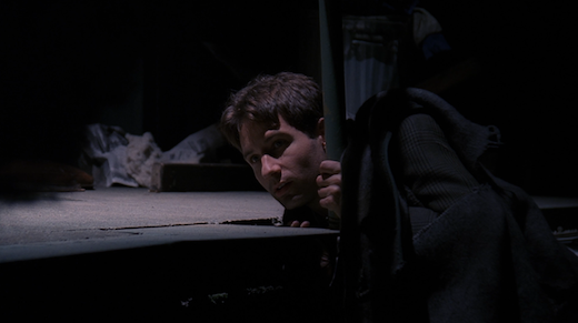 Mulder leans directly into the light while trying to get a look at the Jersey Devil.