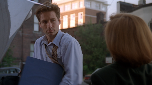 Mulder looks down at Scully.