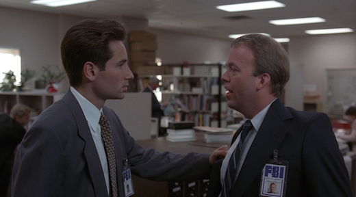 Mulder confronts Jerry, grabbing the lapel of his coat. 