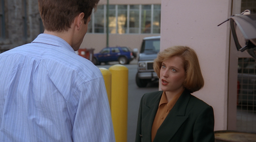 Scully is looking up at Mulder.