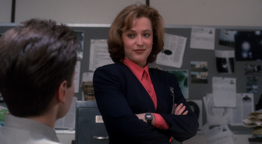 Scully smirks at Mulder.