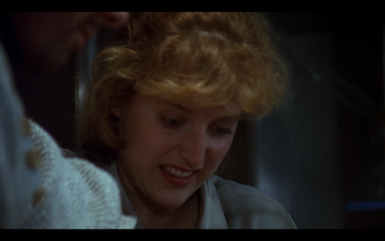 Scully grimaces as she catches sight of the worm in Bear's neck.